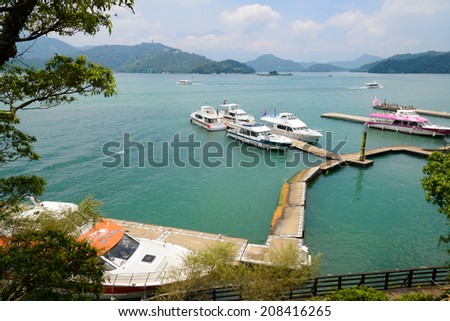 SUN MOON LAKE - JULY 15: boats parking at the pier on July 15, 2014 at Sun Moon Lake, Taiwan. Sun Moon Lake is the largest body of water in Taiwan as well as a tourist attraction.