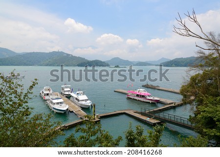 SUN MOON LAKE - JULY 15: boats park at pier on July 15, 2014 at Sun Moon Lake, Taiwan. Sun Moon Lake is the largest body of water in Taiwan as well as a tourist attraction.
