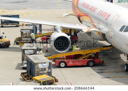 HONG KONG - MAY 16: Cargoes being unloaded from a Hong Kong Airlines at Hong Kong airport on May 16, 2014 in Hong Kong. Hong Kong Airlines is one of the most busy carriers in the region.