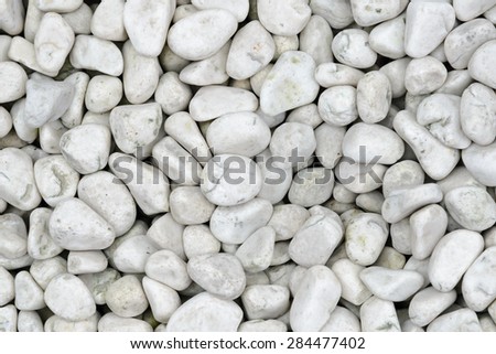 Small naturally polished white rock pebbles background