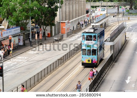 HONG KONG - JUNE 8, 2015: double-decker tram on street of HK. Hong Kong Tramways is a tram system in Hong Kong, being one of the earliest forms of public transport in the metropolis.