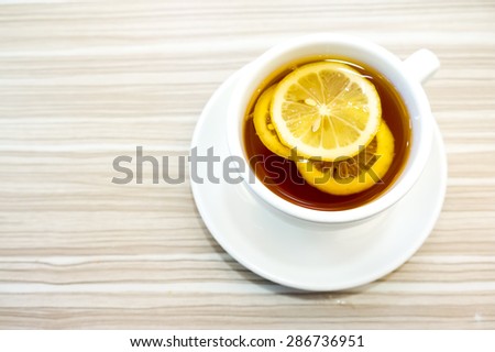 Cup of tea with lemon on table close-up