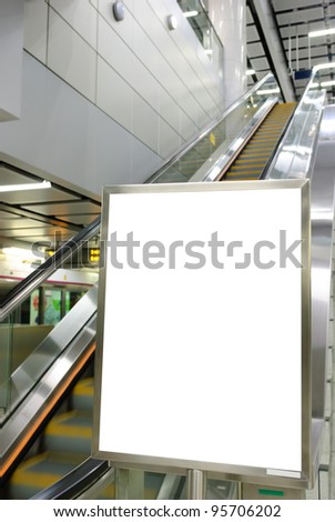 One big vertical / portrait orientation blank billboard with escalator background