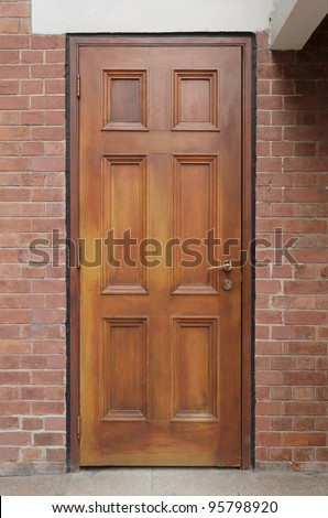 Brown wooden door on brick wall