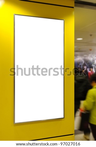 One big vertical / portrait orientation blank billboard on modern yellow wall with sport light and blued passenger background