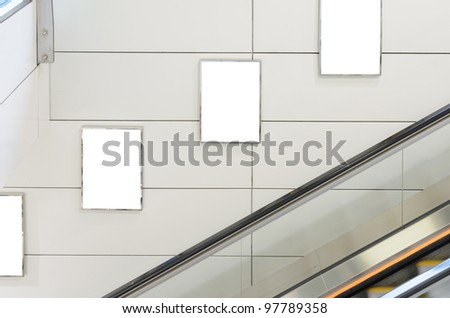 Three big vertical / portrait orientation blank billboard with escalator background