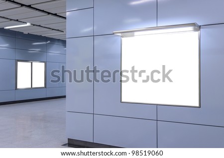 Two big vertical / portrait orientation, one big horizontal / landscape orientation blank billboard on modern blue wall with corridor background