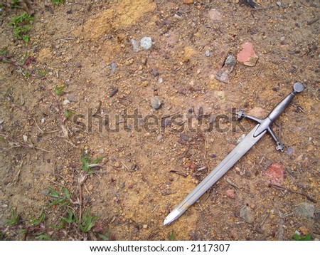 Sword on gravel dirt background
