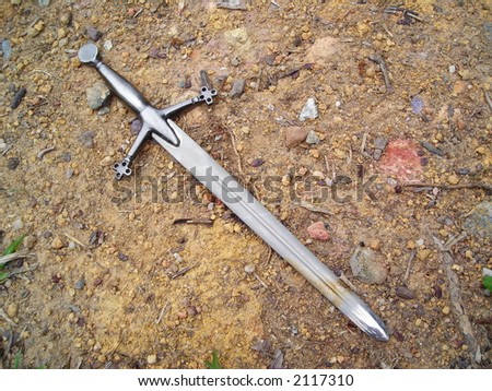 Sword on gravel dirt background