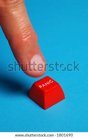 finger pushing red panic button