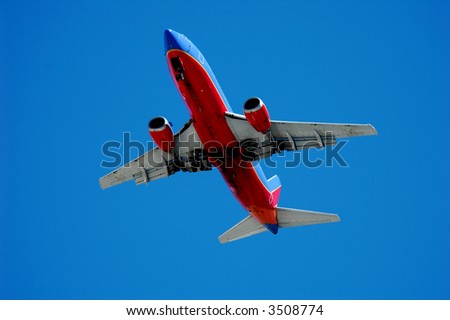 Twin engine jet plane overhead on flight path to land, landing approach, 4