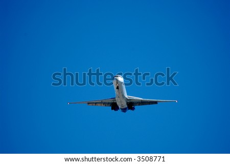 Twin engine jet plane overhead on flight path to land, landing approach, 6