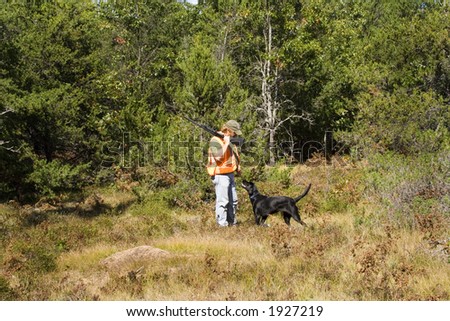 Man and dog out bird hunting in northern michigan