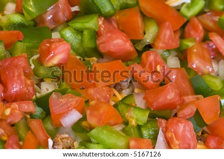 close up of red and green cut bell peppers