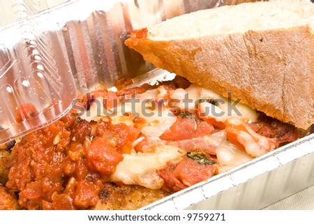 carry out meal chicken parmesan with a slice of bread in the carry out container