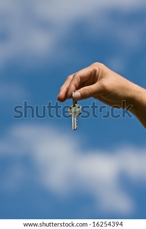 woman handing another woman keys to a house