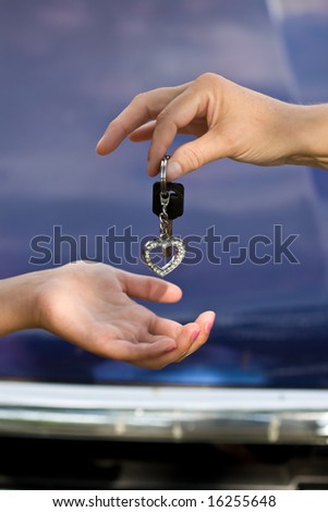 hands and car keys woman heart on key chain