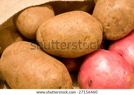 burlap bag of potatoes spilling out of the bag