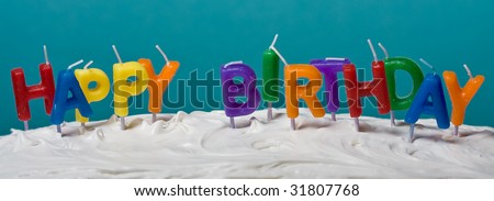 candles on a white frosted cake blue background banner