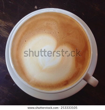 Hot latte arts coffee cup with heart steam milk