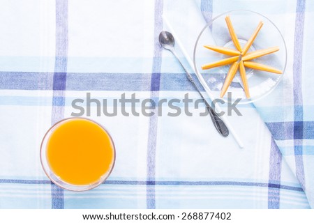 Fresh baby carrots circle explode on blue table mat