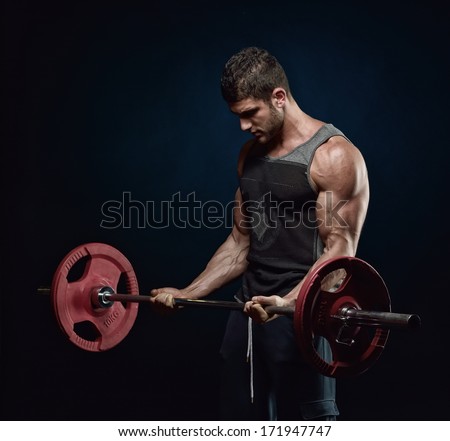 Athletic Young Man Lifting Weights