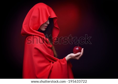 beautiful woman with red cloak holding apple in her hand