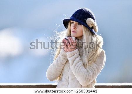 beautiful happy smiling winter woman with mug outdoor holding cup with hot drink
