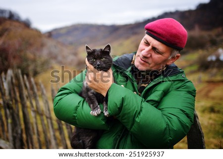 man holding black cat