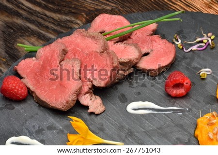 slices of duck fried meat in fancy food arrangement