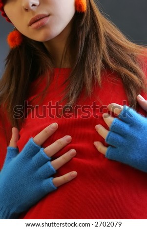 girl with red t-shirt, red earrings and blue gloves