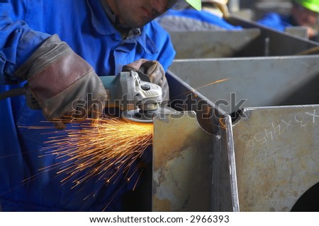 worker grinding, finishing metal, steel