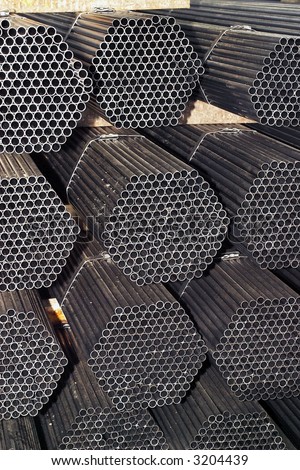 stack of packed rounded welded steel pipes