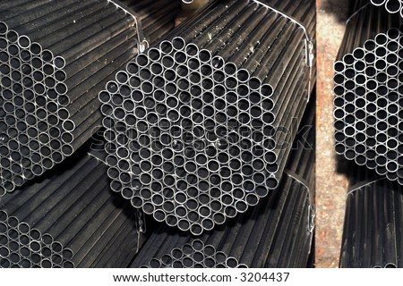 stack of packed rounded welded steel pipes