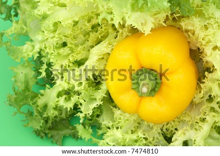 yellow pepper and salad on green background