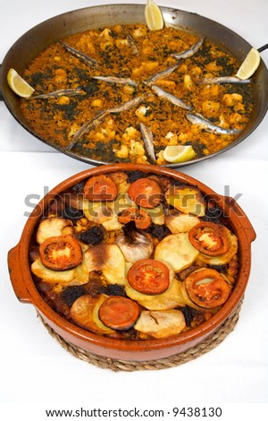 close-up of cooked spanish food with rice, fish and vegetables