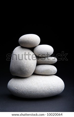 pile of white river stones on black background