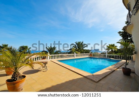 swimming pool with blue water in the yard of a luxury house