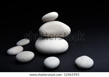 pile of white river stones against black background