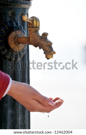 leaking drops of water falling in a woman´s hand
