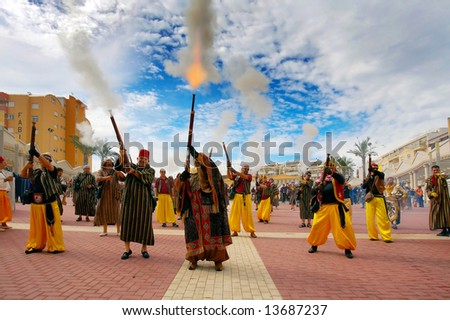 people firing/shooting with weapons during a spanish fiesta - moors and christians