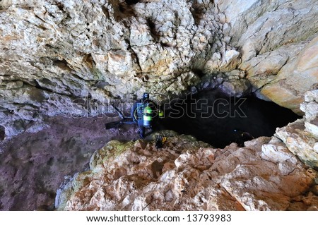 divers diving in a cavern