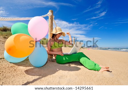 girl with colorful balloons jumping on the beach