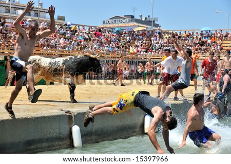 Denia, SPAIN - JULY:spanish people in fiesta - bulls in the water - moraira, alicante - spain, july 2008