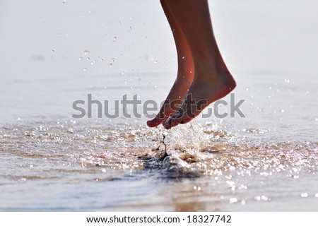 nice woman legs jumping in the water