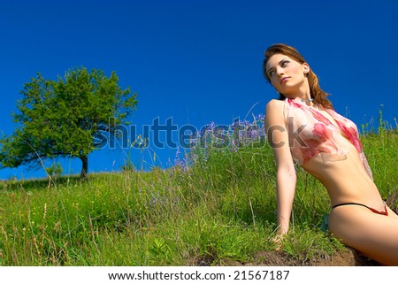 beautiful sensual woman on field in spring