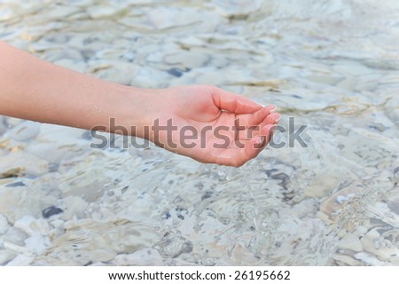 woman hand in the water