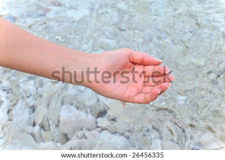 woman hand in the water