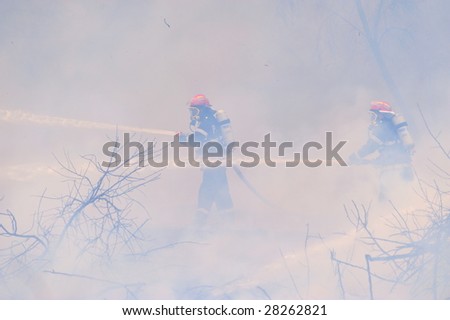 flames during big fire and firemans