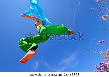 young woman with blue scarf jumping